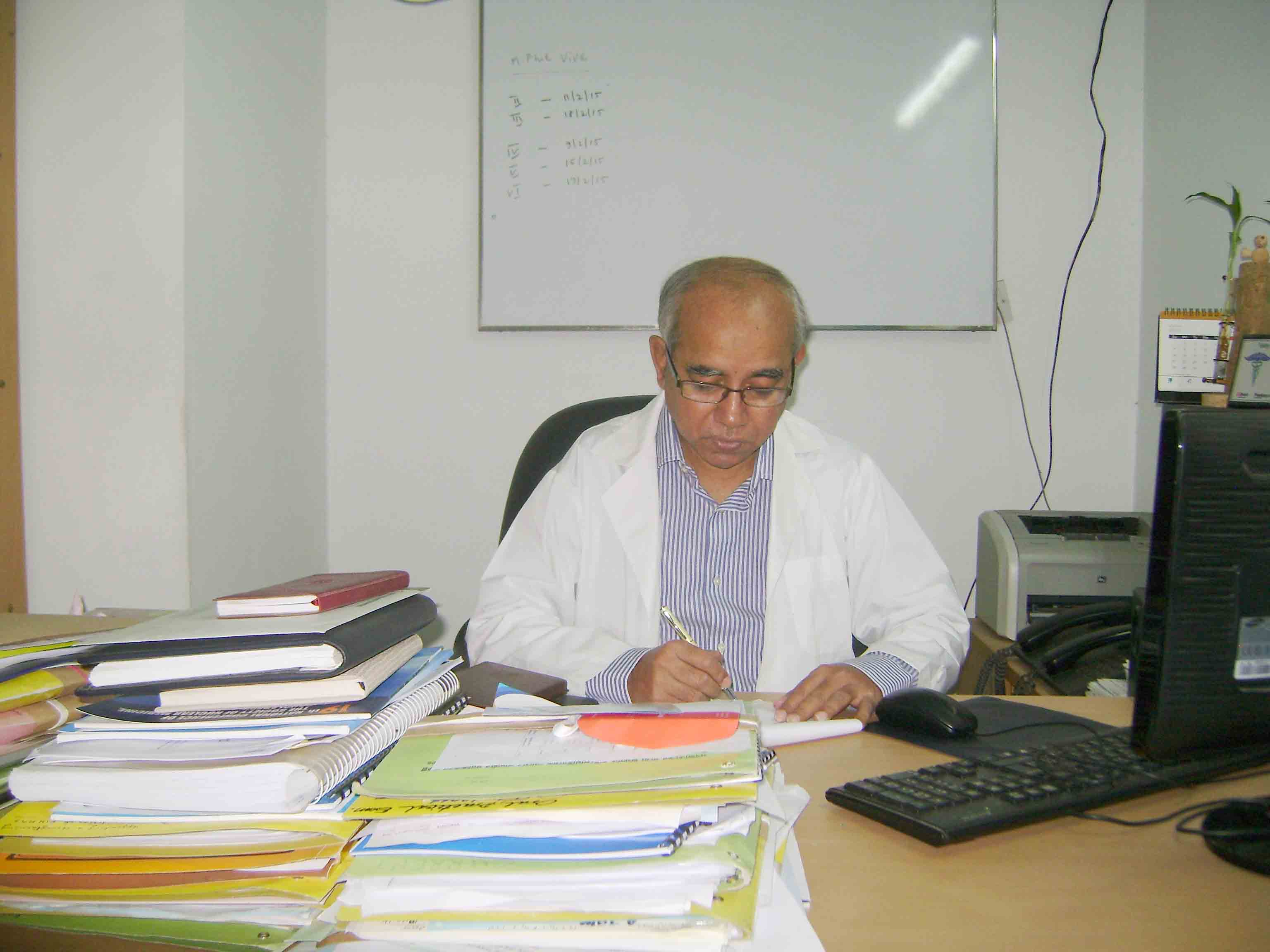 Professor Dr. Mizanul Hasan is seen working at his office..